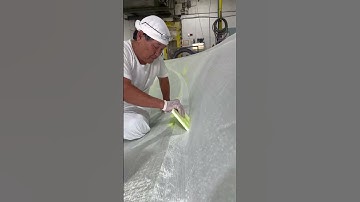 Adding fiberglass to a hull before vacuum infusing #fiberglass #boats #howitsmade