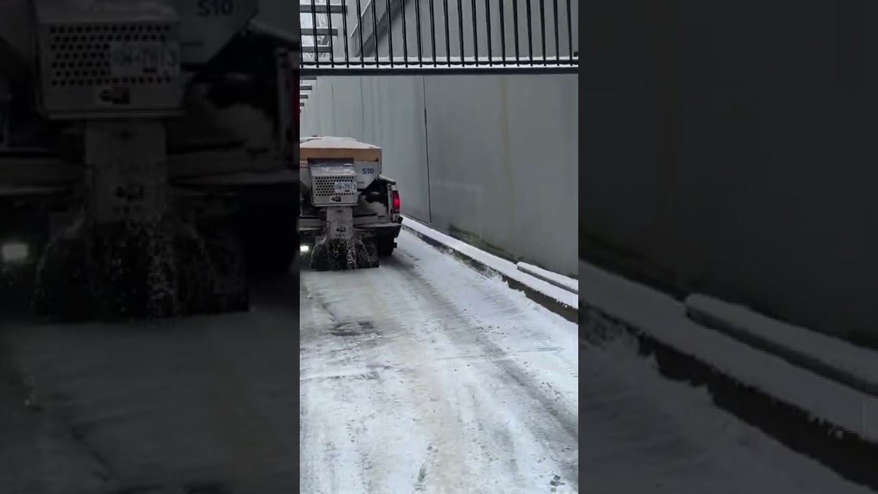 A Snow plough is working for spray melt salt after heavy snow in Vancouver