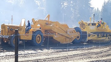 Caterpillar D8H Bulldozer pushing a CAT DW15 Tractor Scraper