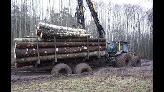 : Valtra forestry tractor logging in wet spring forest, big load