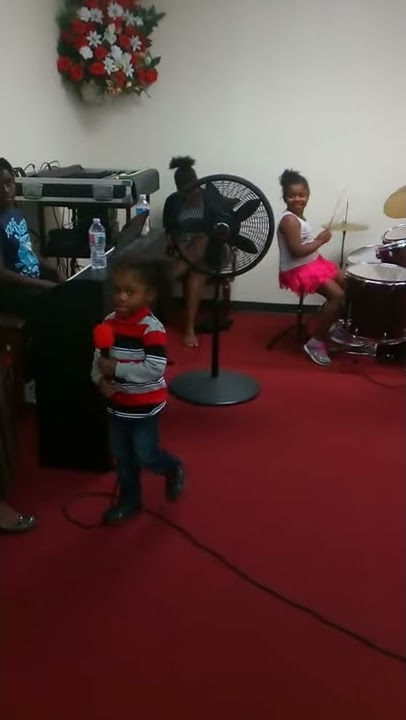 DJ singing with siblings in church.