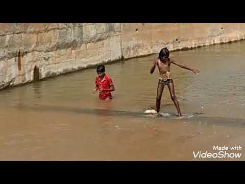 A village girl showing her stunt in the river