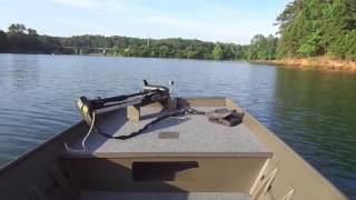 Jon boat with side console on the lake. 