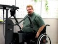 A paraplegic shows how to use a StrapStand standing device