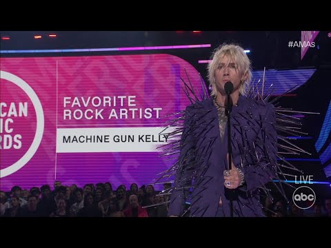 Machine gun kelly accepts the 2022 american music award for favorite rock artist - the american musi