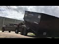 Loading a 18 yard dumpster to my roll off trailer
