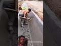Construction Workers Smoothing Cement with a Cement Rake
