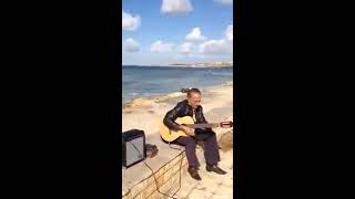 old man play guitar in syria 2016