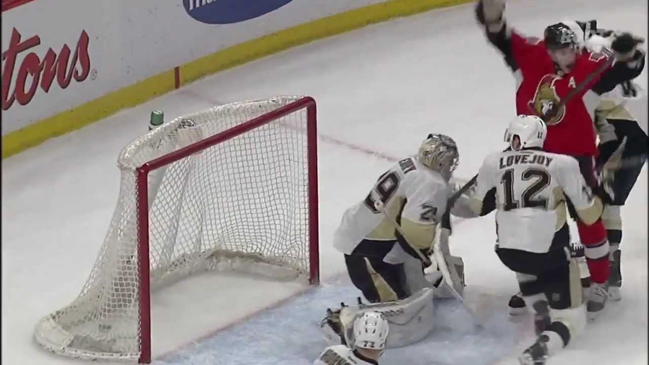 Young hockey goalie performs a moonwalk during a break in the action