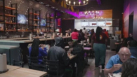 Customers brave the rain on the grand opening of Shaq's new restaurant in North Texas