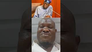 A man reads from the book of Bola Tinubu 