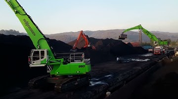 Sennebogen 860 R Unloading Coal from Barge.