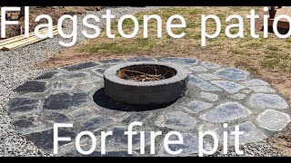 Building a flagstone fire pit surround.