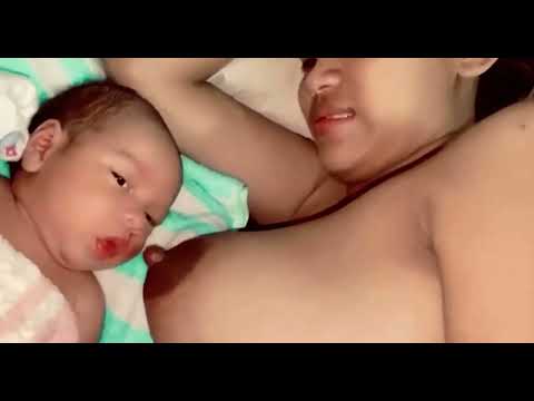 Breastfeeding tutorial Cute baby drinking breast milk from her Indian mom while breastfeeding