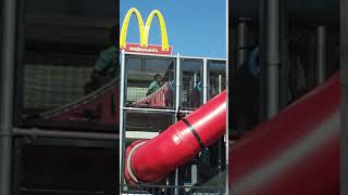 Birds fly near boy as he plays in McDonald's ball pit