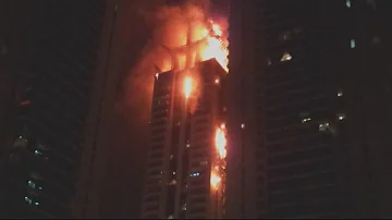Huge fire rips through Dubai skyscraper raining fireballs onto the ground below