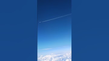 Airplane Flying In Opposite Direction Of Another Airplane