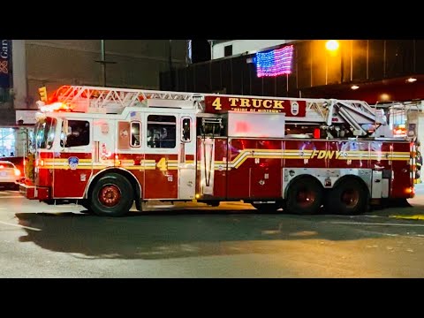 FDNY LADDER 4 RESPONDING FROM QUARTERS ON 8TH AVENUE IN MIDTOWN AREA OF MANHATTAN IN NEW YORK CITY.