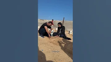 زوجة مصور الجزيرة محمد سلامة تجلس منهارة بجانب قبره 