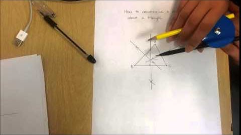 How to circumscribe a circle about a triangle by straightedge and compass construction