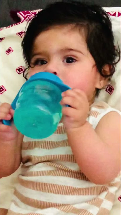 Thirsty baby drinking water in Philips avent sippy cup