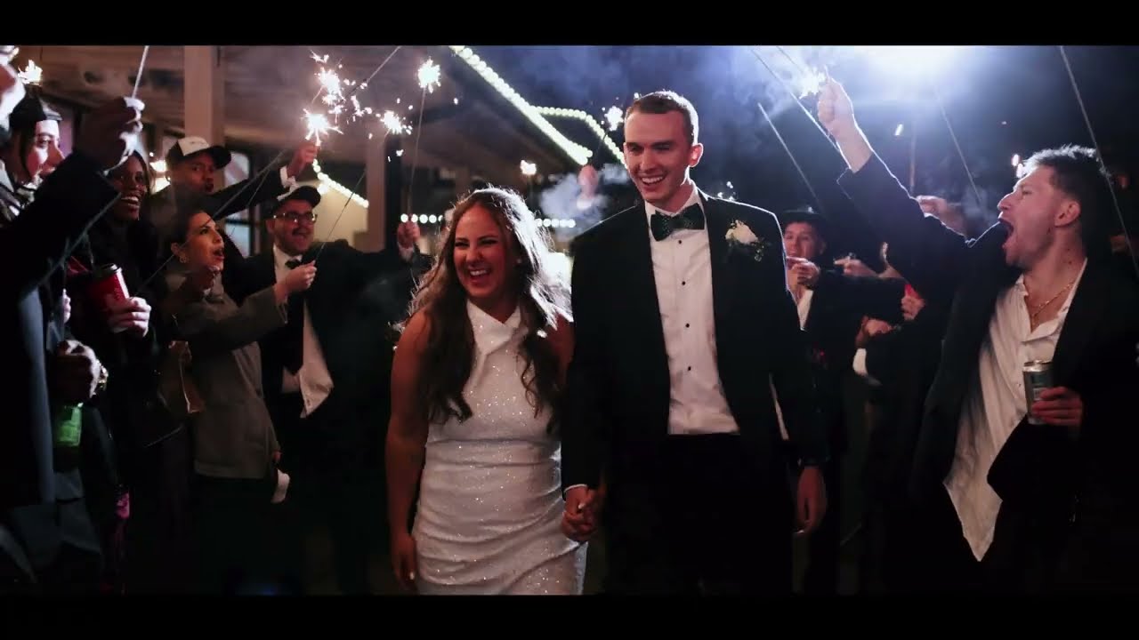 Bride and groom celebrating under string lights as guests cheer at Meadows at Mossy Creek in Cleveland, GA