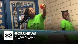 Brooklyn students learning to play tennis without a court