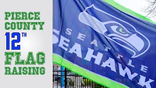 Pierce County employees raise the Seahawks flag
