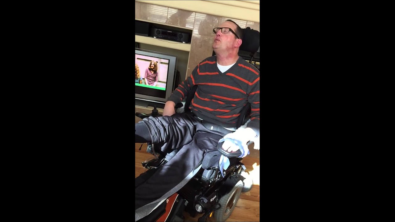 Man with MS in wheelchair moves legs