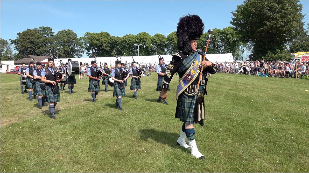 Drum Major mace flourish as Towie Pipe Band march off field during 2023