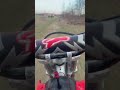 Tank cam view riding Honda CRF150 over table top jump