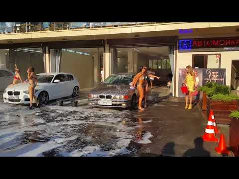 Business idea of a girl model in a bikini erotic car wash