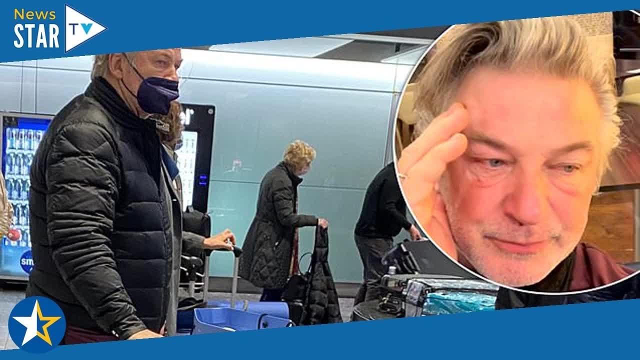 Alec Baldwin cuts a glum figure while picking up his luggage at ...