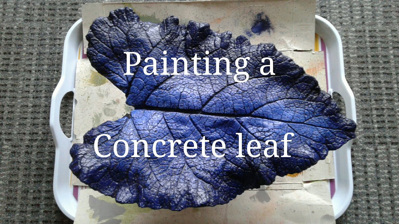 Painting a concrete leaf with acrylic paints. Concrete leaf painting