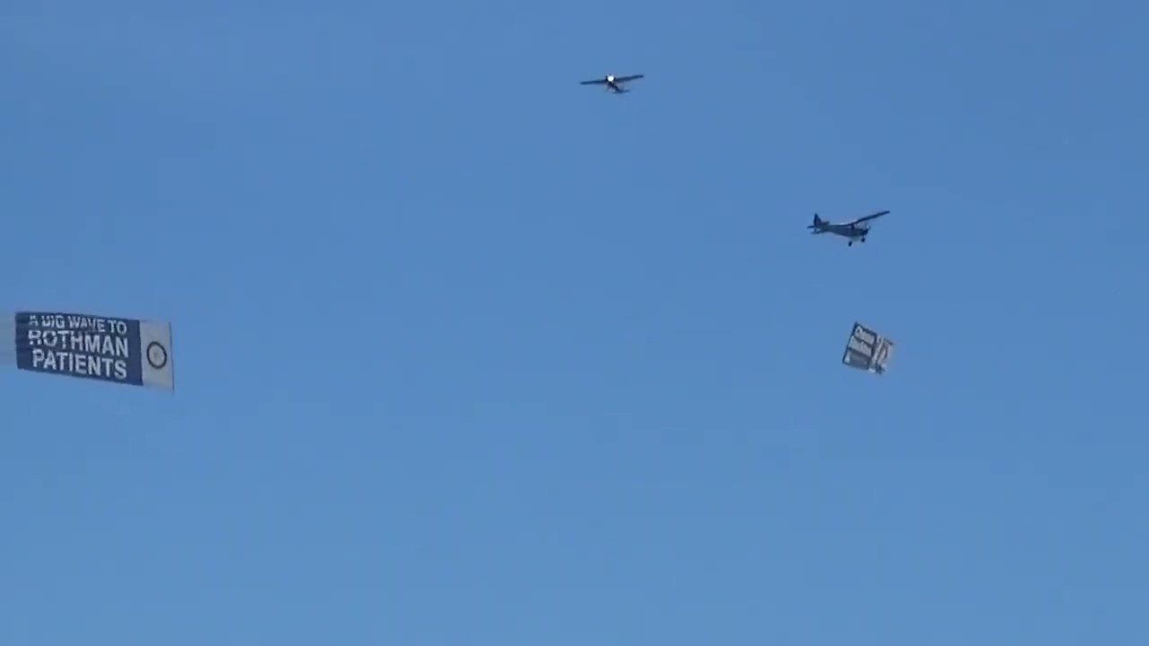Piper J-3 Cub towing the banner across the Cessna 150 towing the banner 8/30/2019