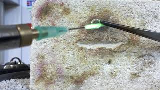 Soldering close a jump ring with hydrogen-generating micro torch.