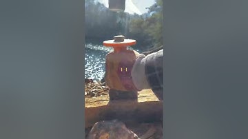 Hand splitting rust colored slate for Mosaic art.