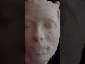 Sculpting female head in clay.
