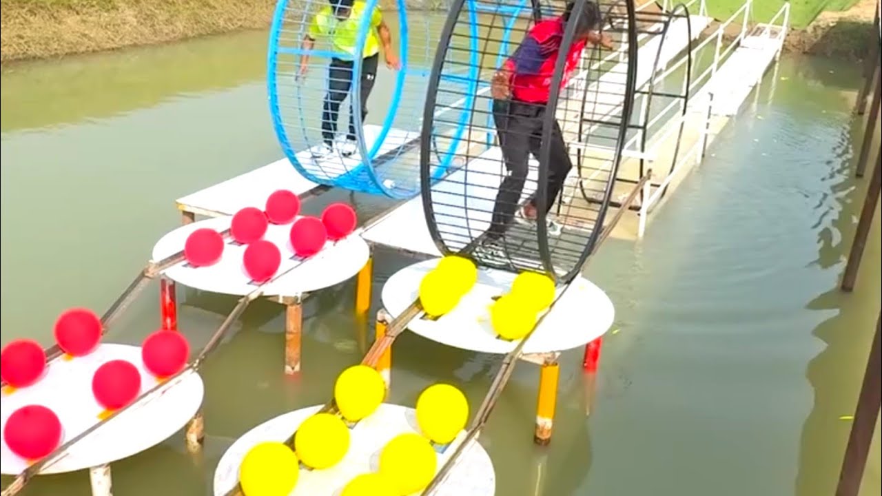 Two people fight in the funny game of bursting balloons placed on the road by crushing the iron bars