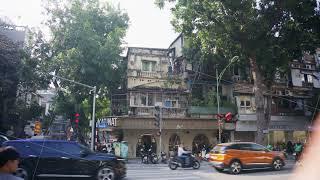 Urban landscape in Hanoi, Vietnam showcasing busy intersection with constant car and scooter traffic