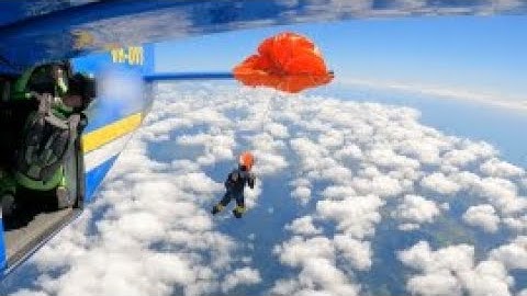 Skydiver dangles from aircraft at an altitude of 4,500 meters