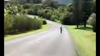 kid waveboards down a really steap hill
