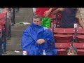 Fan struggles to put on poncho at Fenway Park