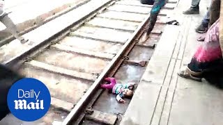 One-year-old falls on train racks and miraculously survives