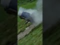 Старенький миникупер летит с обрыва. An old minicooper flies off a cliff.