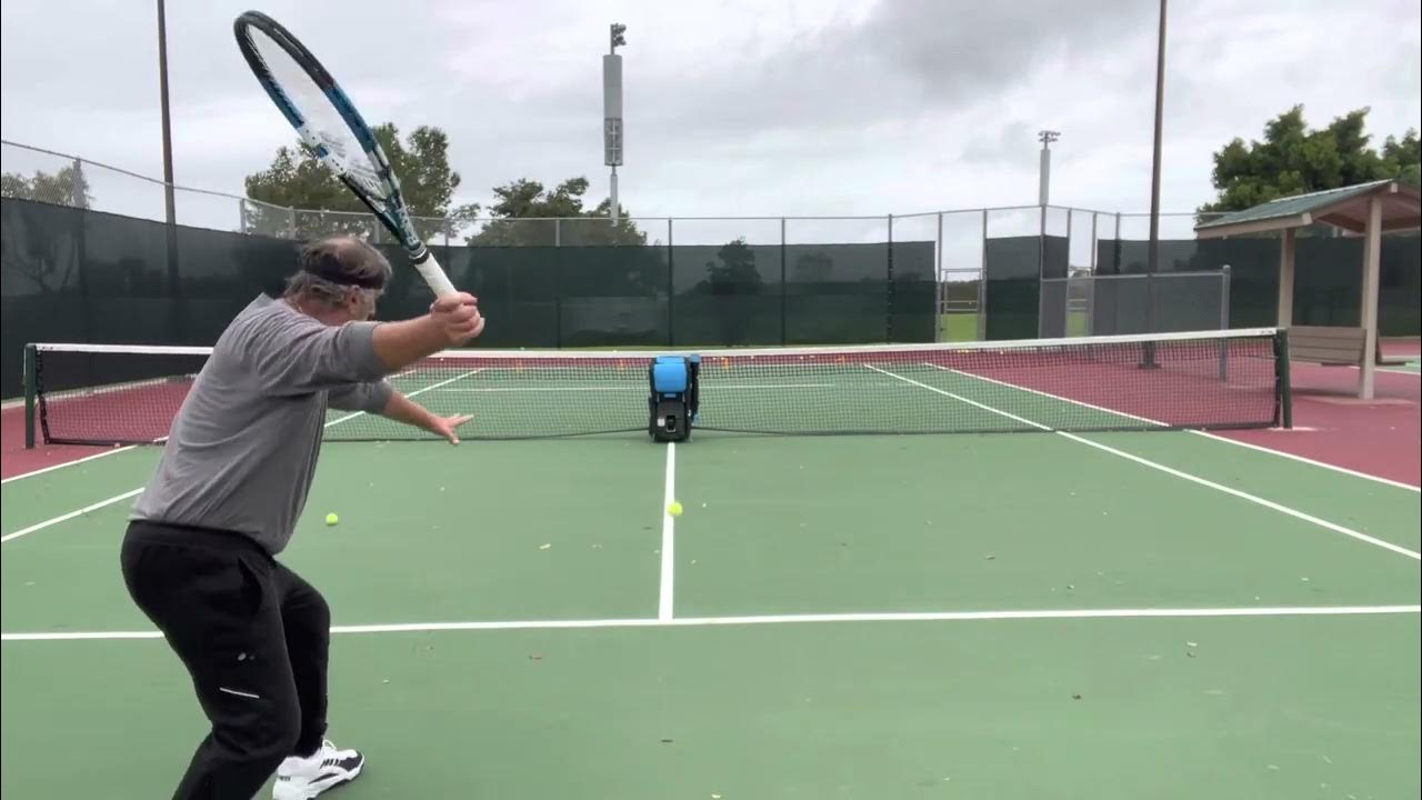 Practicing with the Slinger Ball Machine in between the raindrops YouTube