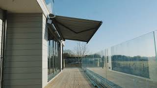 A retractable patio awning at a beautiful countryside home