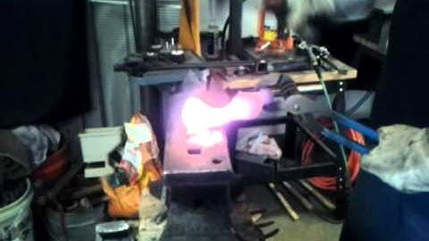 Hands forging a tomahawk