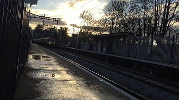 DB Schenker 66128 Passing Through Reading West with colourful graffitied stone hoppers