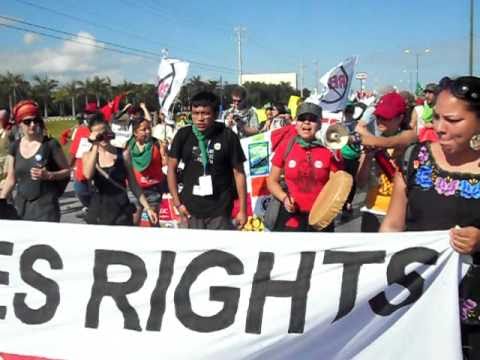 Jasmine Thomas sings during COP 16 march